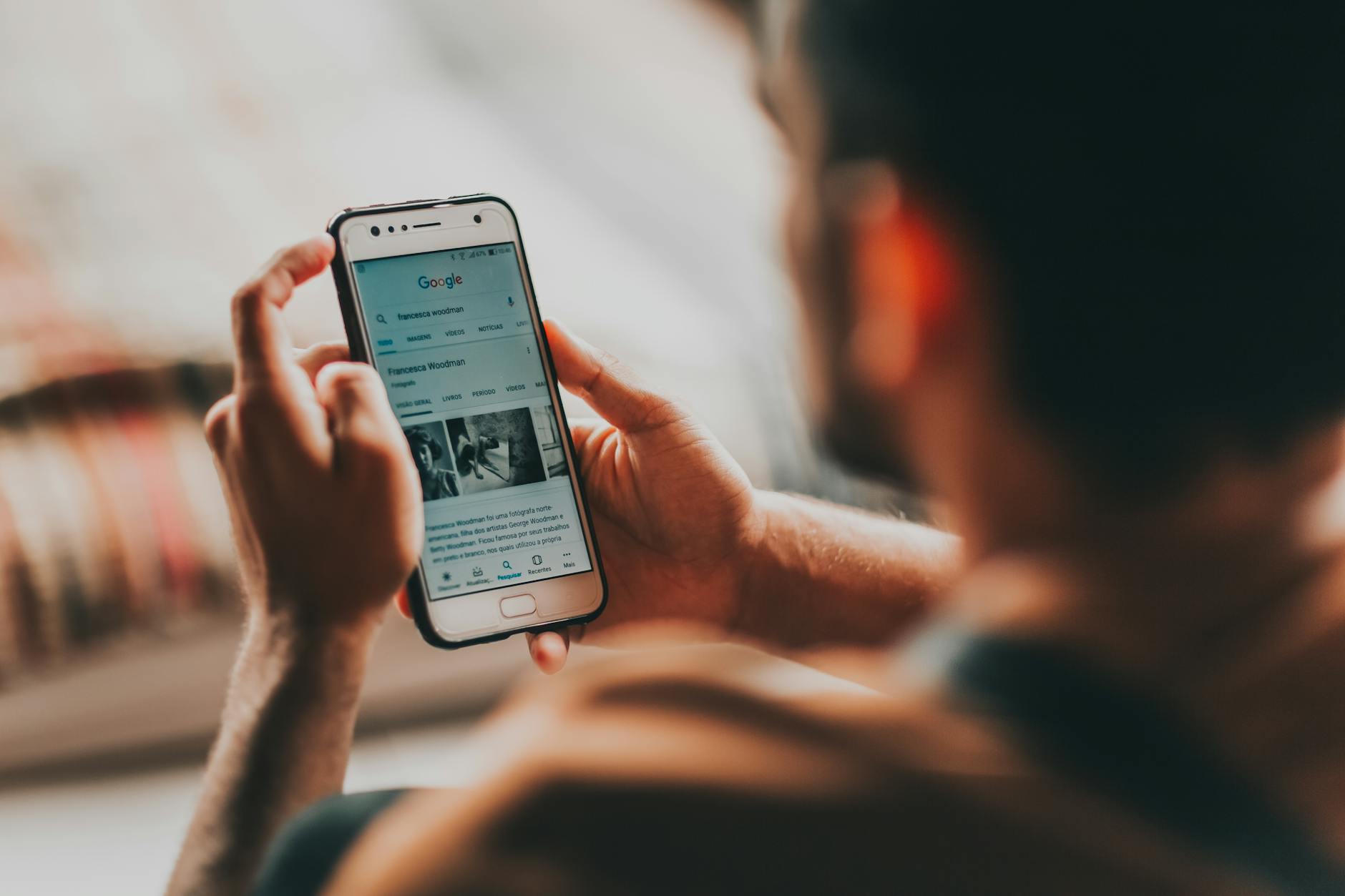 crop man surfing internet on smartphone at home